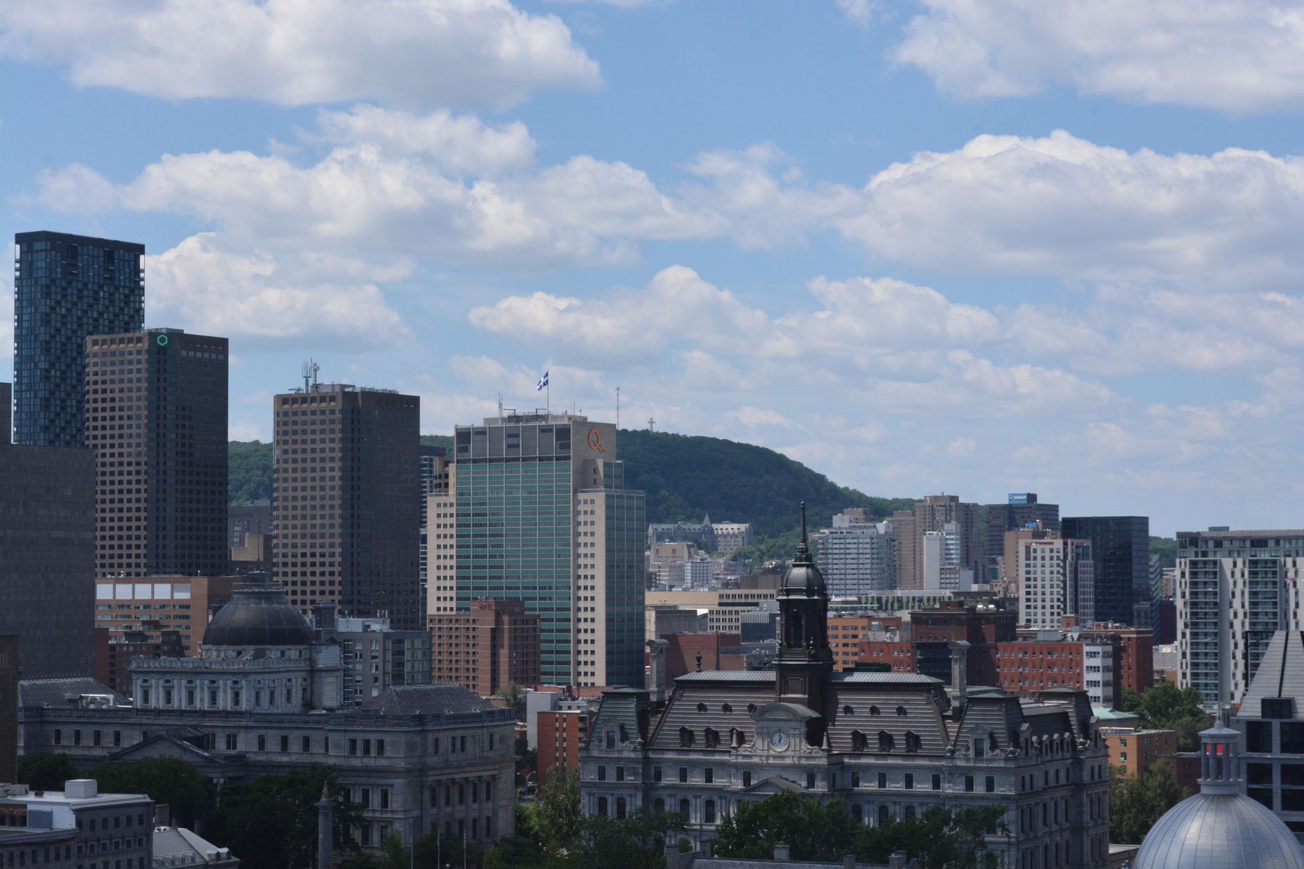 The Montreal skyline seen across the city, the urban setting around IGA Stadium in Jarry Park