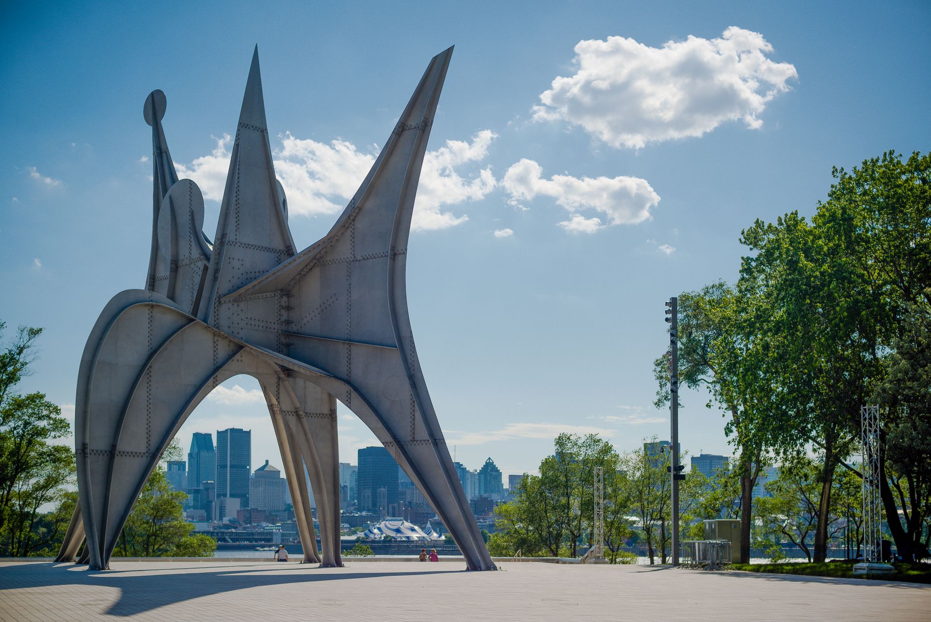 A tidy urban neighbourhood park in Montreal on a clear day, in the manner of the free public courts at Médéric-Martin Park