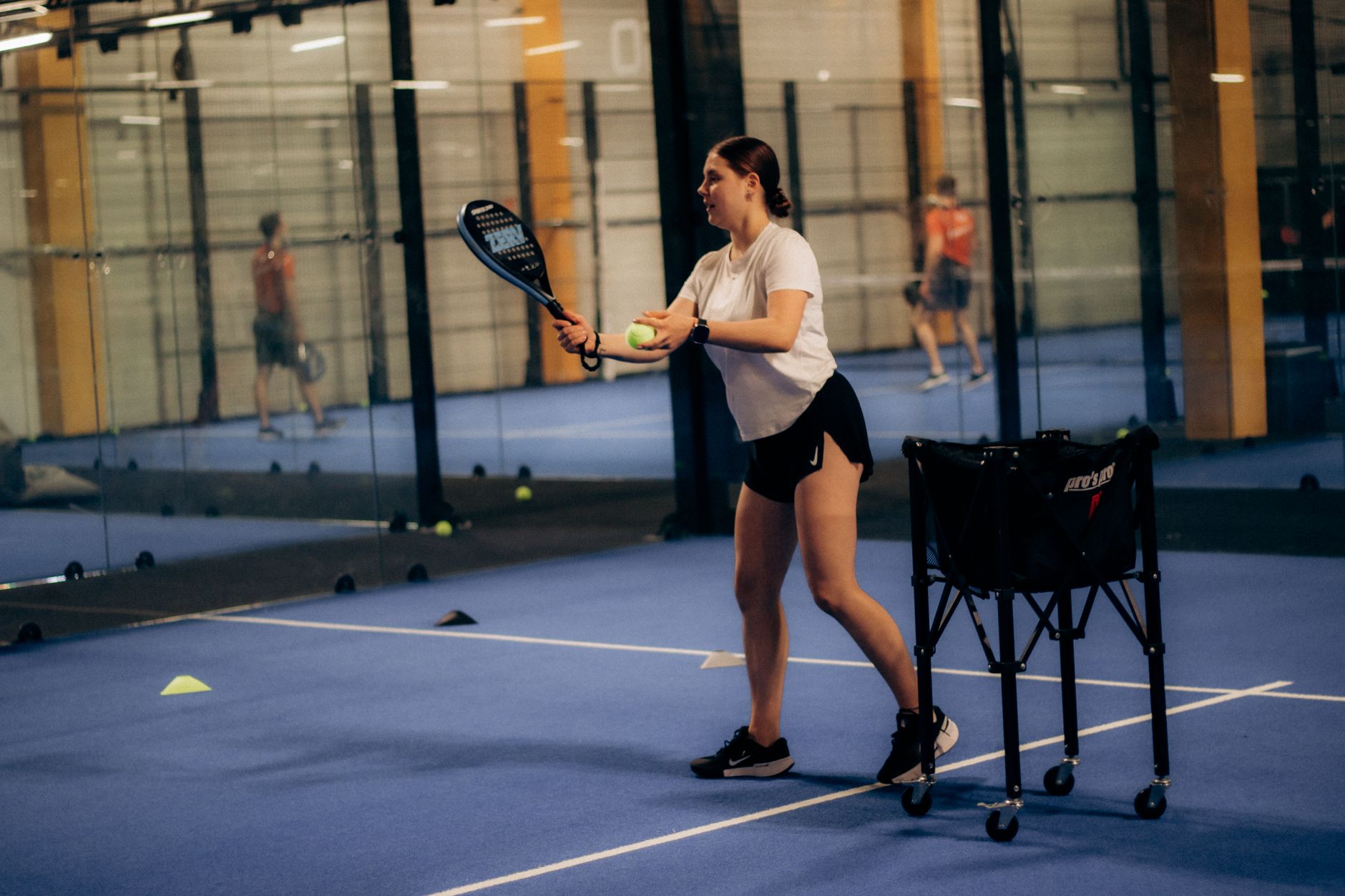 A polished private indoor tennis club interior, representative of the hard and clay courts at Tennis Île des Sœurs in Verdun