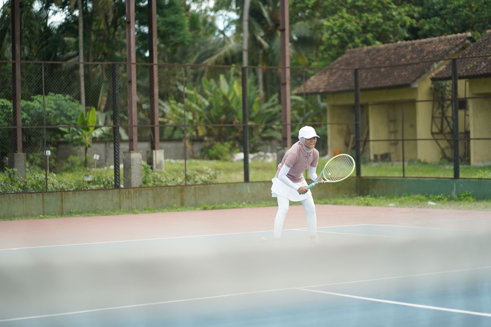 Outdoor tennis courts on a clear day, representative of the Pickering setting where Quest Tennis Academy coaches