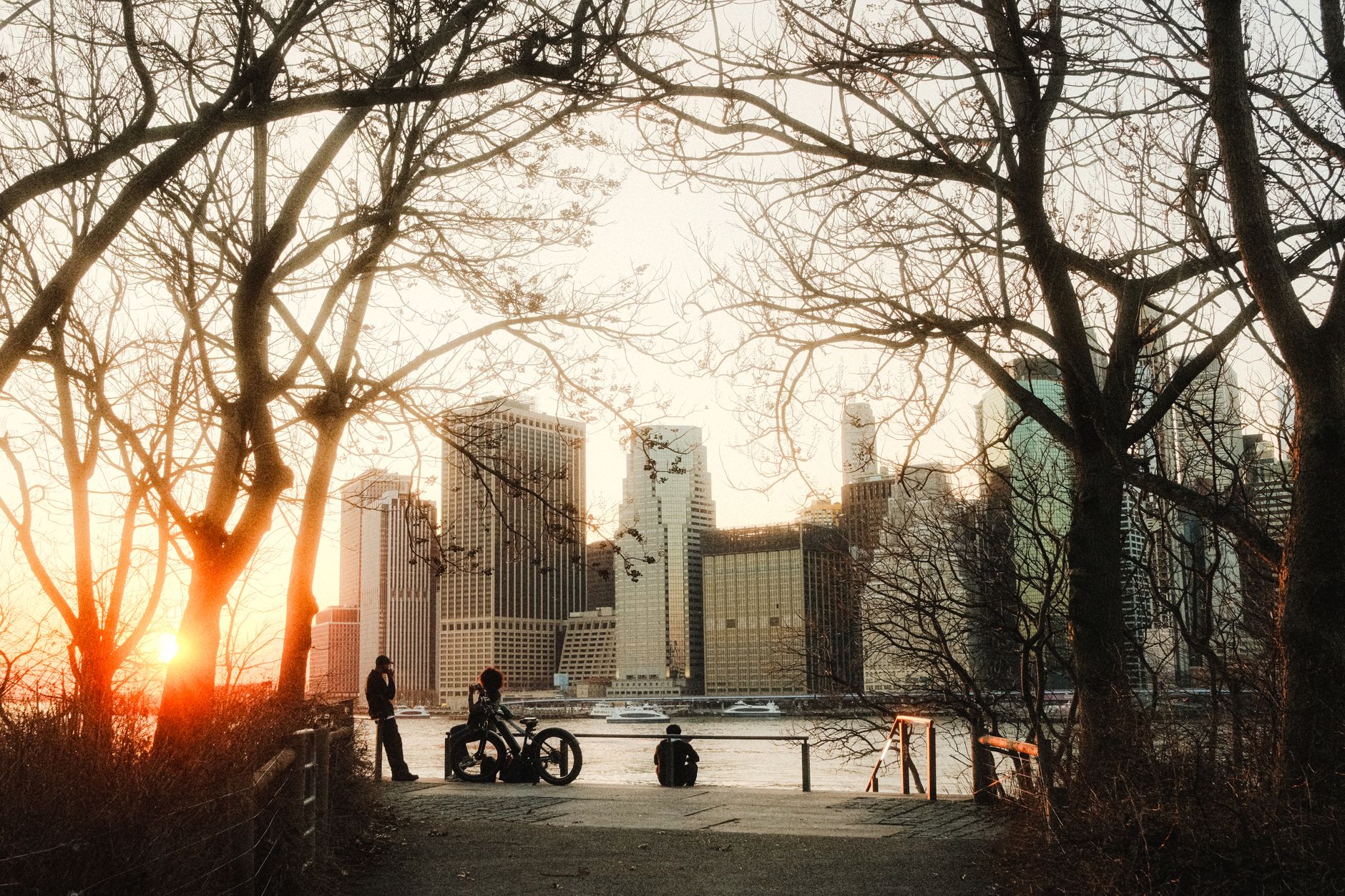 The Manhattan skyline beyond a green park in north Brooklyn near McCarren Park