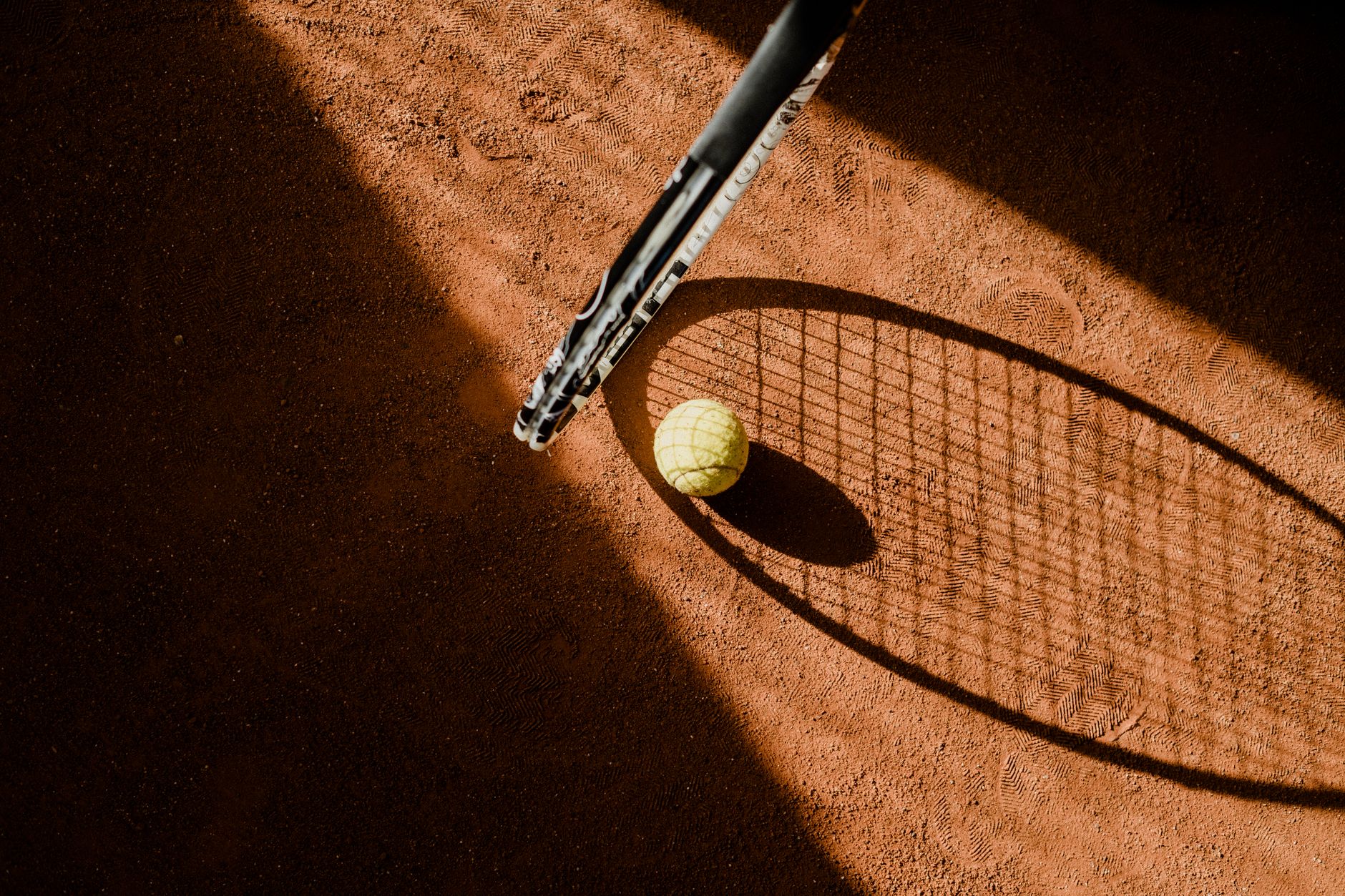 Tennis equipment on a court, representing the Matchpoint Tennis shop in Oshawa