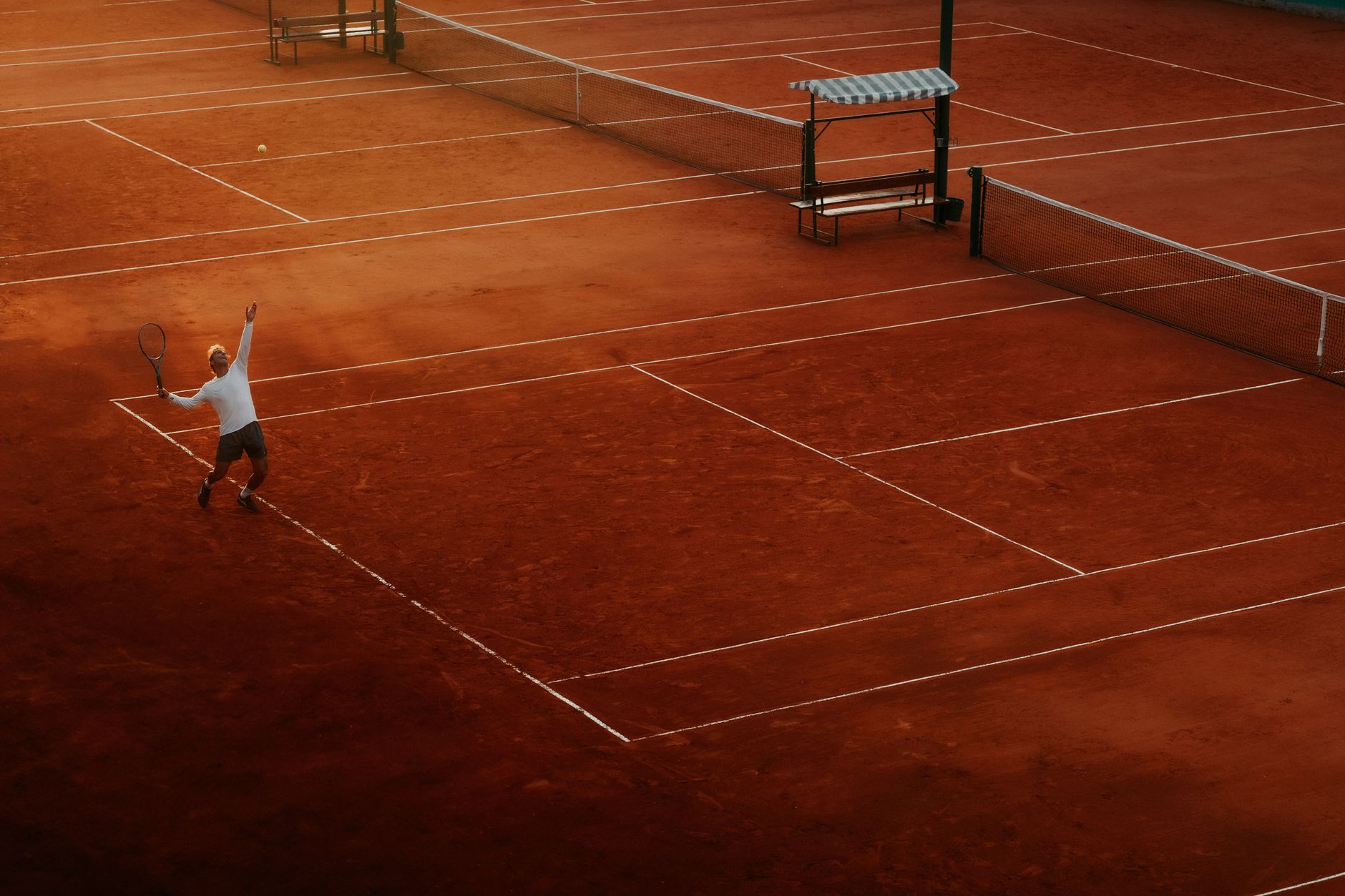 Six Har-Tru clay courts and two hard courts on an urban block, in the style of the Hamilton Tennis Club