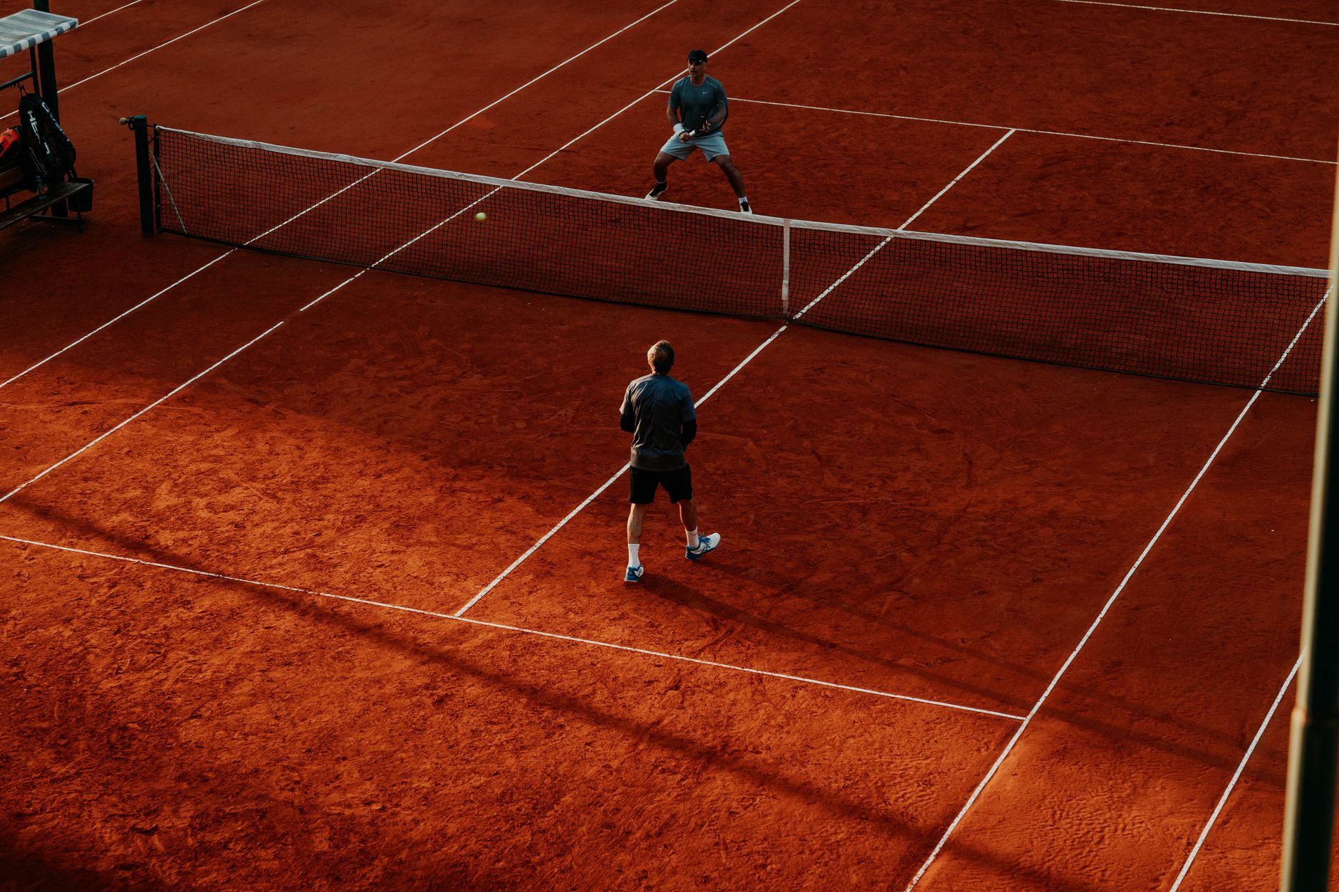 Har-Tru clay and hard courts in a leafy residential neighbourhood, in the manner of Rockcliffe Lawn Tennis Club in Ottawa