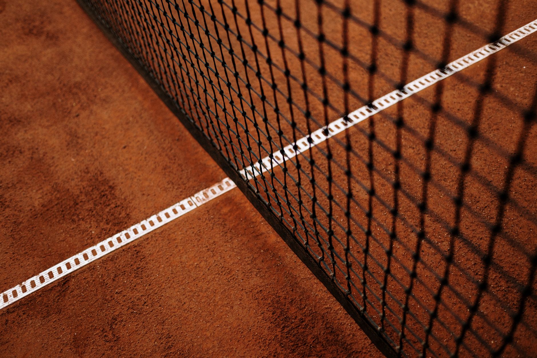 Five clay courts and a hard court beside a river, evoking the riverside setting of the Stratford Tennis Club