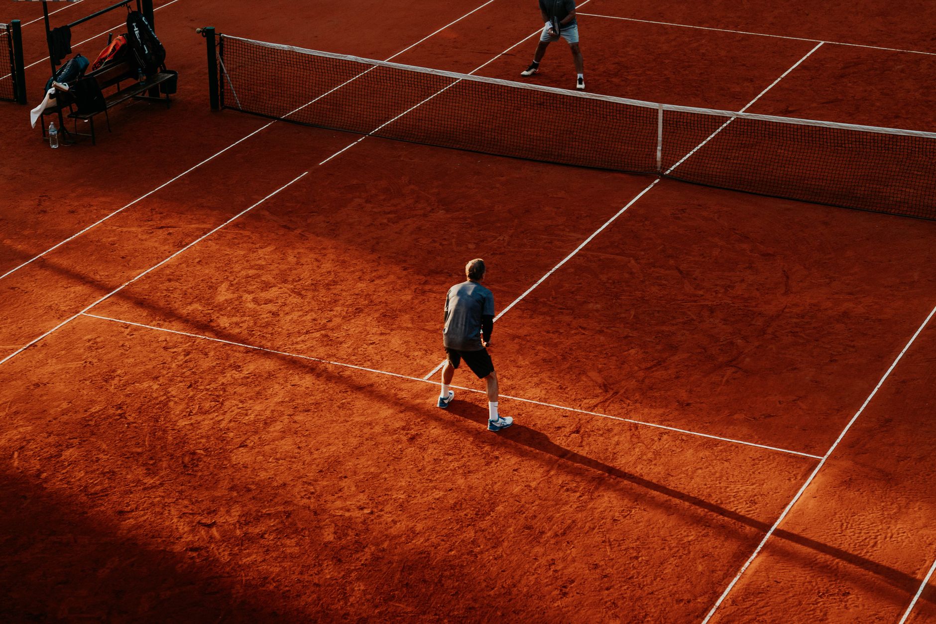 Indoor and outdoor clay courts side by side, in the manner of the Tennis Centre West Ottawa
